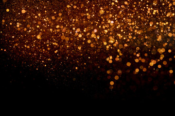 Beautiful, sparkling orange glitter pouring down from above on a dark background