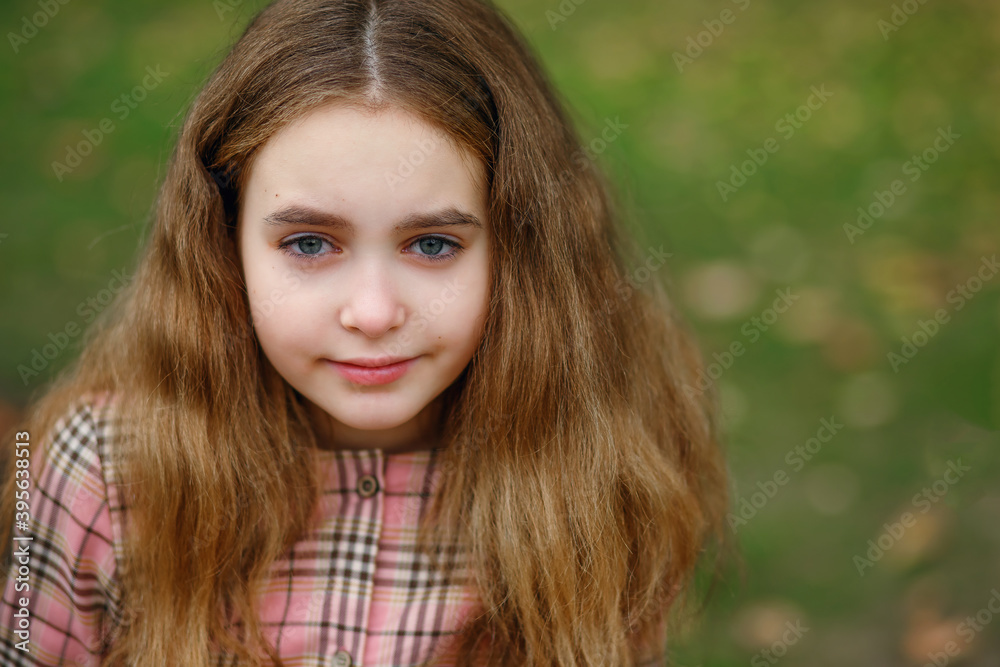 Portrait of a child girl on the background of a green lawn Portrait of a child girl on the background of a green lawn