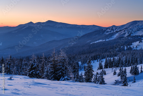 Picturesque winter alps sunrise. Highest ridge of the Ukrainian Carpathians is Chornohora with peaks of Hoverla and Petros mountains. View from Svydovets ridge and Dragobrat ski resort.