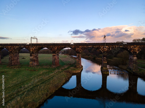 utton Viaduct is a railway viaduct on the West Coast Main Line where it crosses the River Weaver and the Weaver Navigation between the villages of Dutton and Acton Bridge in Cheshire, England