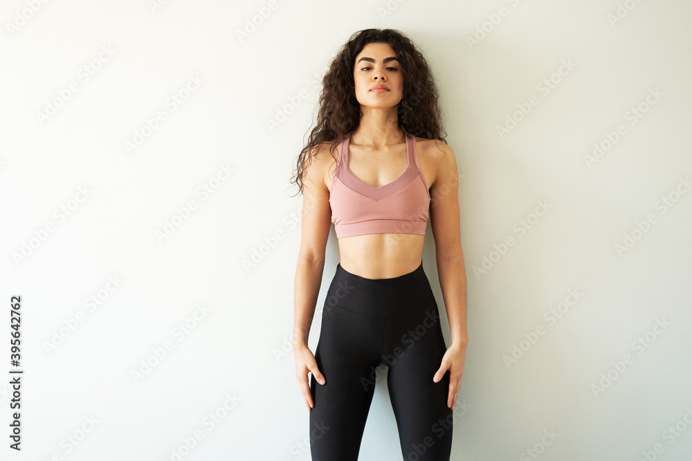 Fitness trainer wearing sportswear making eye contact Fitness trainer wearing sportswear making eye contact