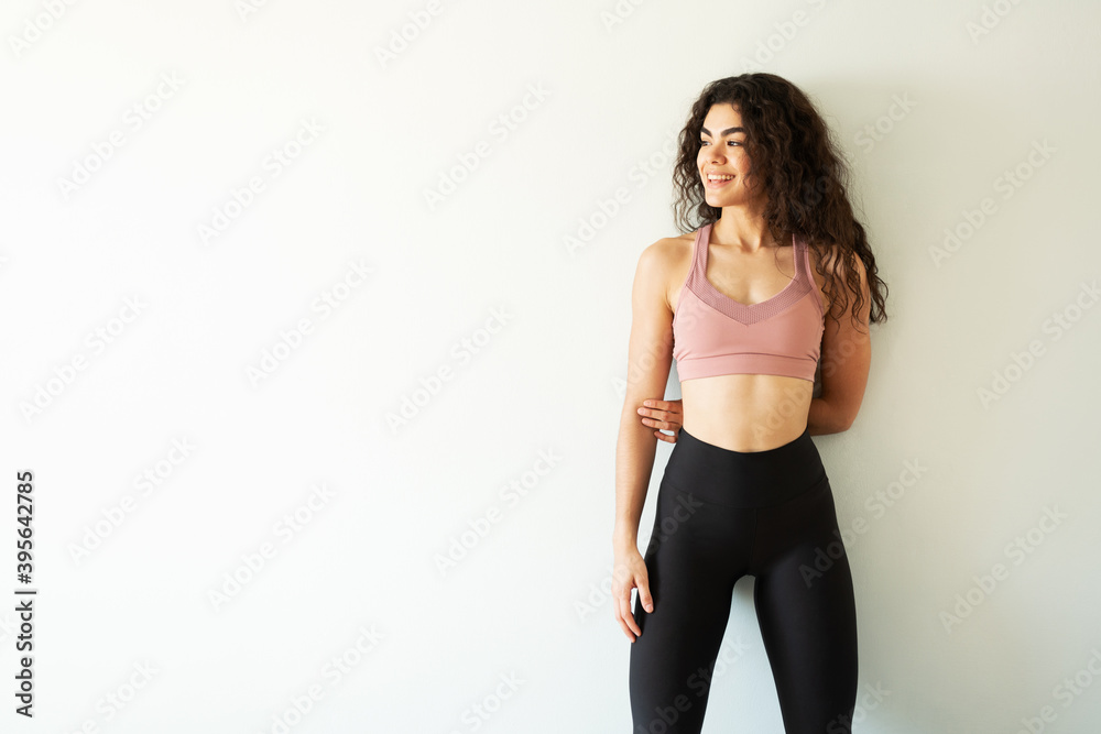Hispanic woman smiling and wearing sporty clothing Hispanic woman smiling and wearing sporty clothing