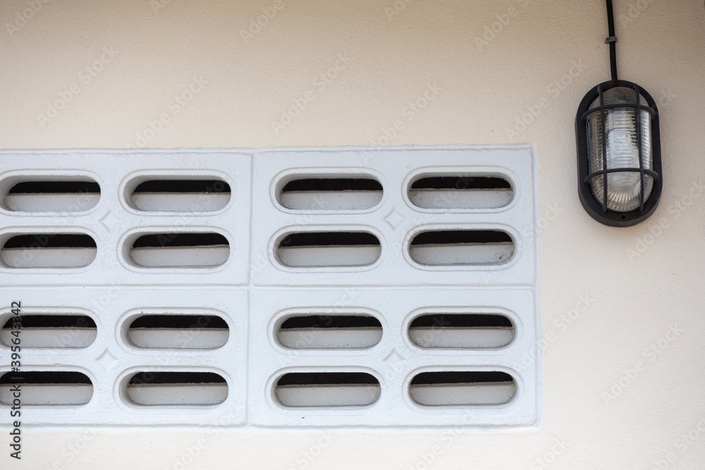 Close up of vent on the white wall. Plastic ventilation grid, piece of home ventilation system Close up of vent on the white wall. Plastic ventilation grid, piece of home ventilation system