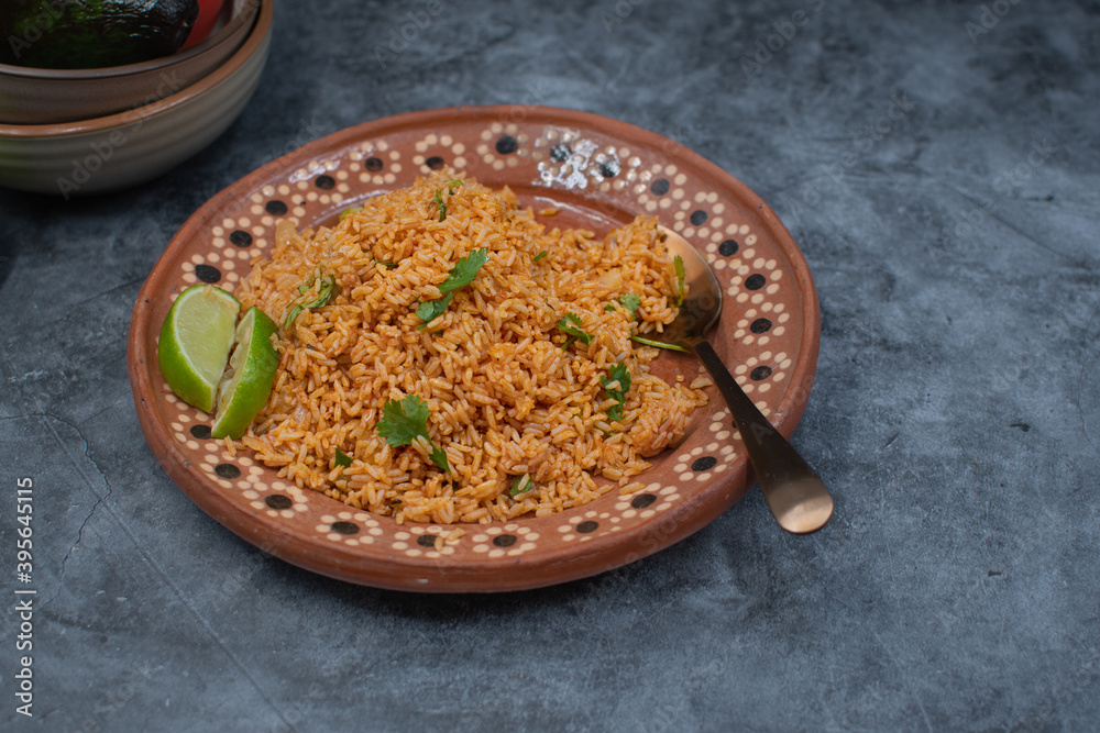Authentic Mexican rice served in traditional clay plate, copy space ...