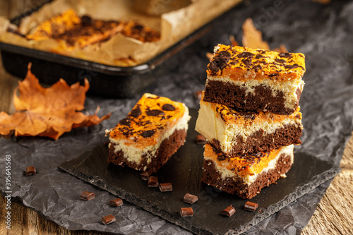 Delicious pumpkin cake with cheese cream and cacao or chocolate on the top