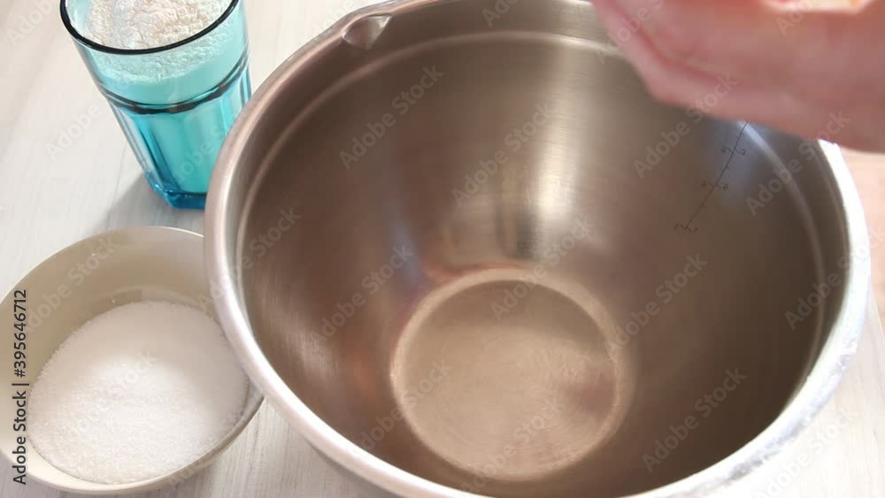 Female hands whipping eggs with a corolla. Close up of female hands making cookies. Nobody Female hands whipping eggs with a corolla. Close up of female hands making cookies. Nobody