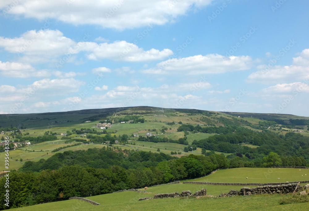 panoramic view across the calder valley in west yorkshire with midgley moor village and farmhouses in summer