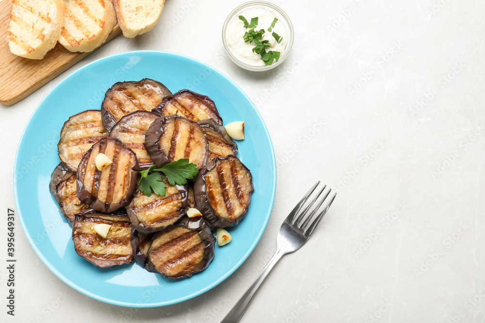 Delicious grilled eggplant slices on light table, flat lay. Space for text
