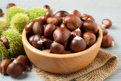 Fresh sweet edible chestnuts in bowl on table