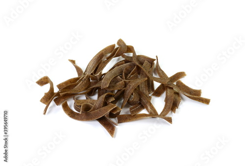 Dry ancooked buckwheat pasta  on white background. Tagliatella pasta noodles isolated on white background. photo