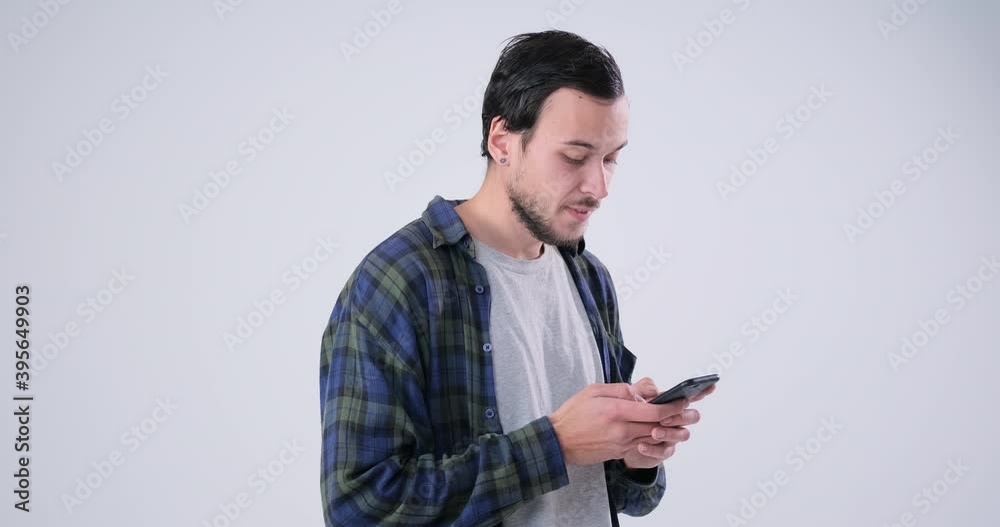 Happy men text messaging on mobile phone over white background