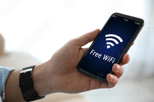Man using mobile phone connected to WiFi, closeup
