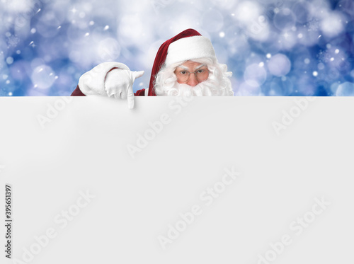 Santa Claus with blank banner on blurred blue background. Space for design © New Africa