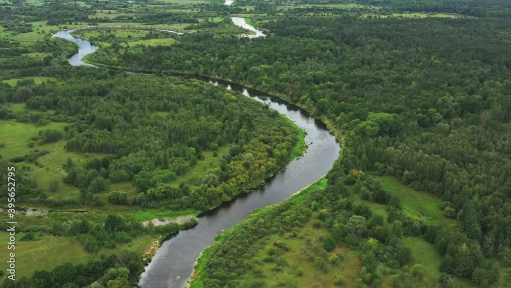 Aerial View Green Forest Woods And River Landscape In Summer Day. Top View Of Beautiful European Nature From High Attitude In Autumn Season. Drone View. Bird's Eye View Aerial View Green Forest Woods And River Landscape In Summer Day. Top View Of Beautiful European Nature From High Attitude In Autumn Season. Drone View. Bird's Eye View