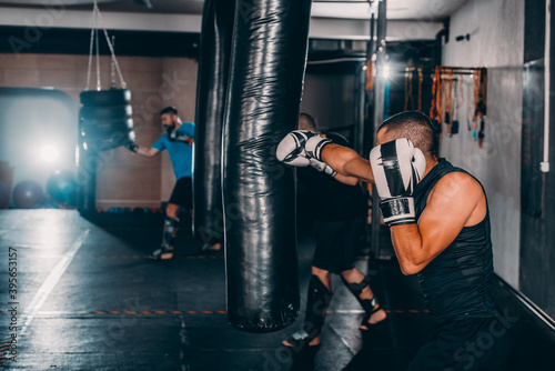 Fearles MMA Fighter practicing his punch on a punching bag photo