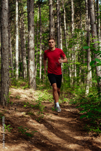 Portrait of a young man trail runner exercising for fitness