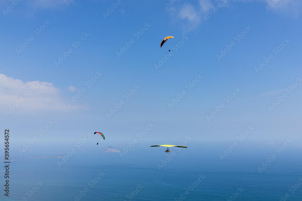 Blue sky with paragliding and hang gliding Blue sky with paragliding and hang gliding