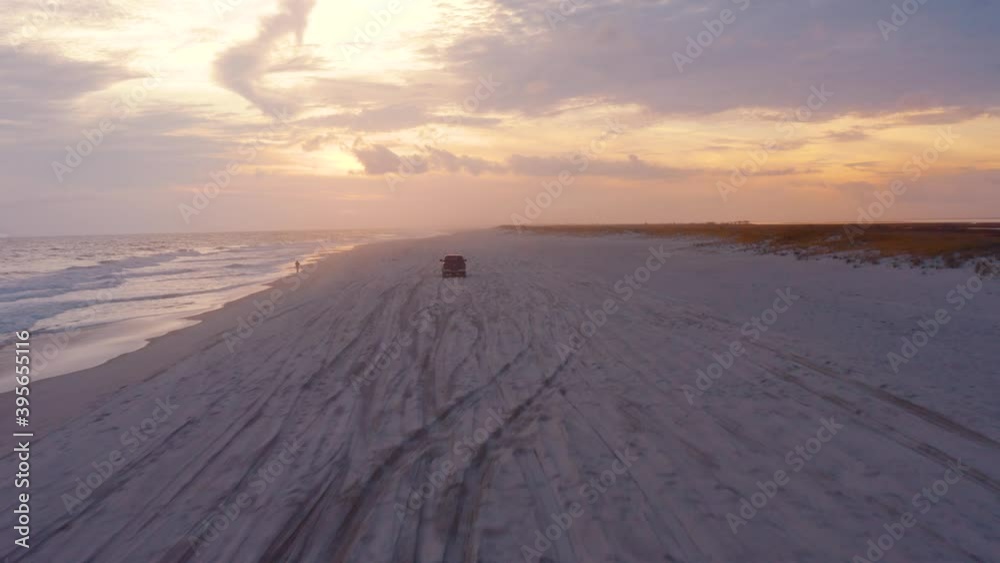 Truck on beach sand with ocean and sunset background Truck on beach sand with ocean and sunset background