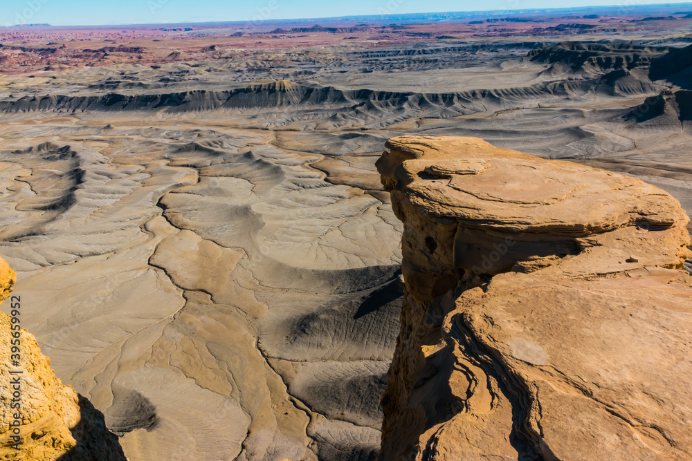 Fototapeta premium Sandstone Outcropping Extending Over The Lunar Like Landscape of Moonscape Overlook, Near Hanksville, Utah, USA