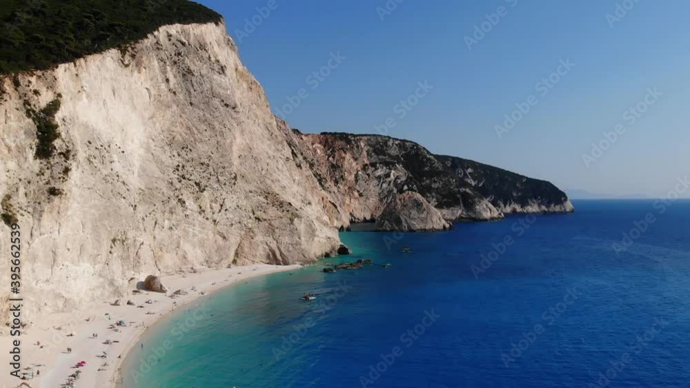 Dream beach from above aerial view. Porto Katsiki rewarded bay with steep white cliffs shot by drone. Beautiful Mediterranean colors. Crystal clear turquoise water surrounded by swimmers. Dream beach from above aerial view. Porto Katsiki rewarded bay with steep white cliffs shot by drone. Beautiful Mediterranean colors. Crystal clear turquoise water surrounded by swimmers.