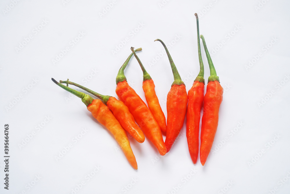 Seven red chilies on a white background Seven red chilies on a white background