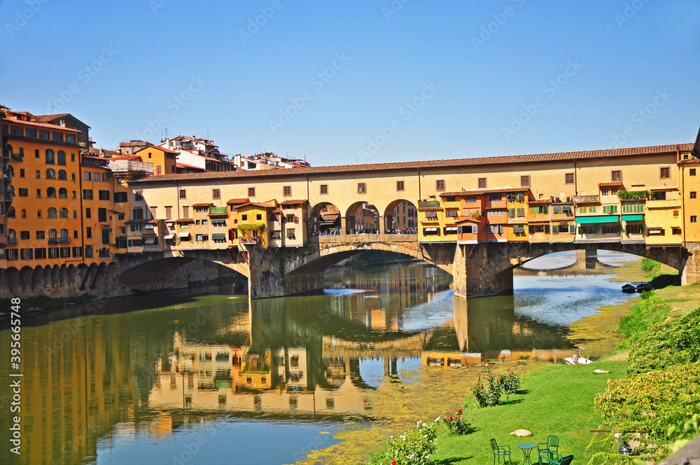 Ponte Vecchio  a medieval  stone bridge in Florence. This is a  landmark covered bridge with jewelry shops and spans the Arno river