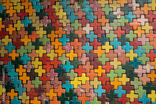 Multi-colored plus-sign jigsaw puzzles arranged in various shapes.