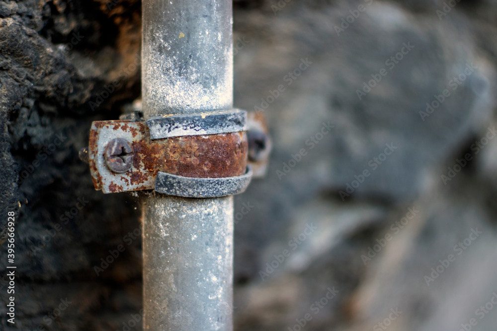 Rusted water or electrical pipe on the wall Rusted water or electrical pipe on the wall
