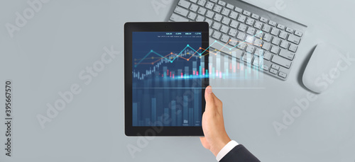 Business plan graph growth increase of chart positive indicators in his business,tablet in hand