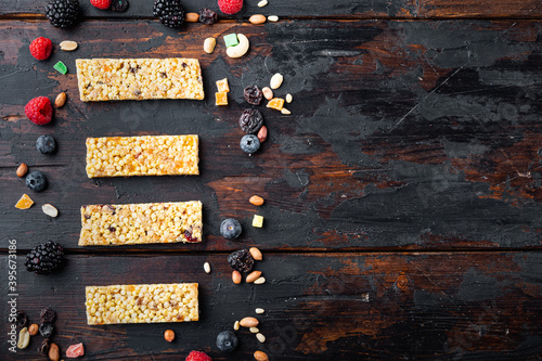 Raw organic granola bars with seeds and nuts, top view with copy space, on wooden table