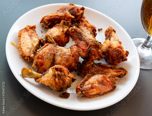 Plate of tasty snack - roasted chicken wings with flavoring