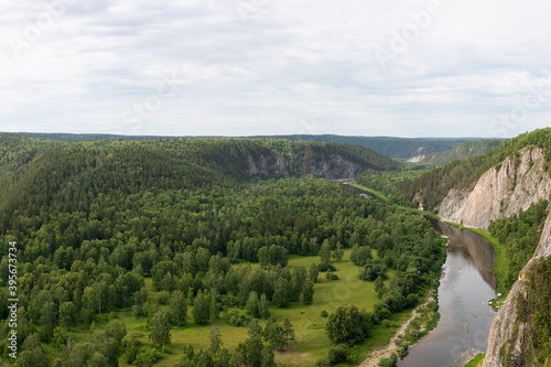 Summer green valley river mountain  landscape. Winding river with overgrown banks, top view. Aerial shot of nature