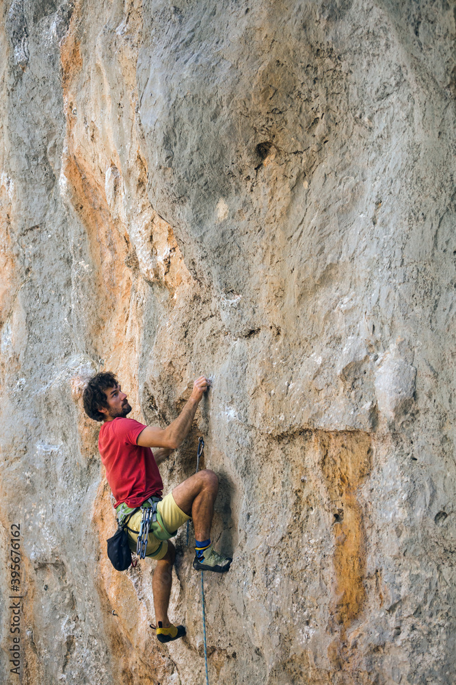 A climber is training on a natural terrain.