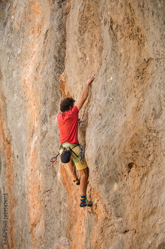 A climber is training on a natural terrain.