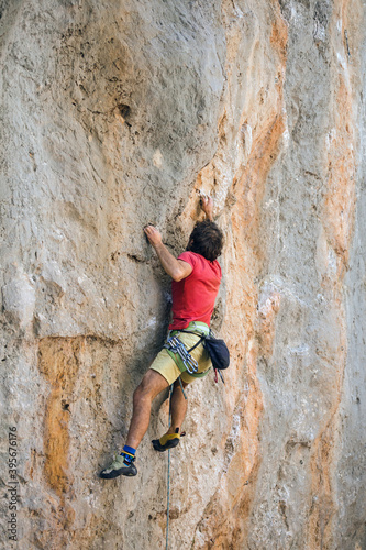 A climber is training on a natural terrain.