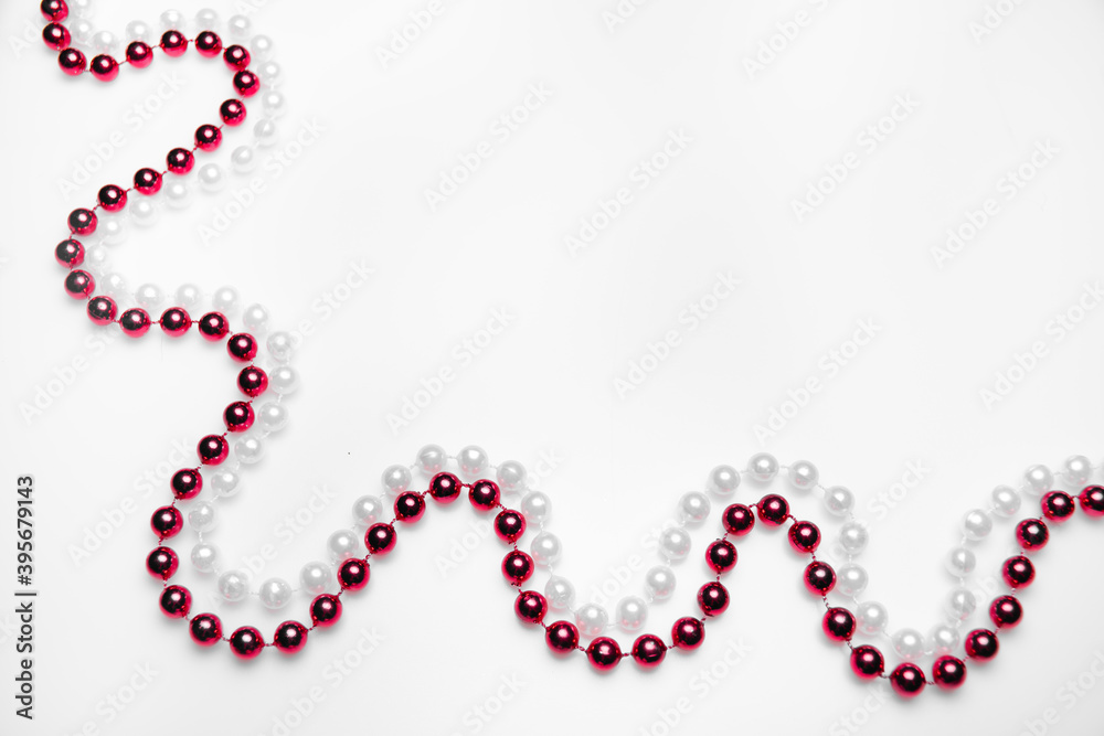 Red and white beads on a white background: place for text, Valentine's day or cardiology, healthy heart