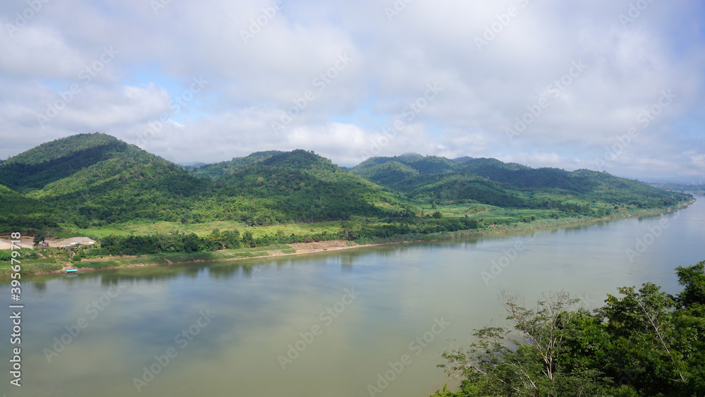 Green Mountain range and Khlong river at the border of Laos from the view point of Chaing Kkhan skywalk, Loei Province , Thailand      
