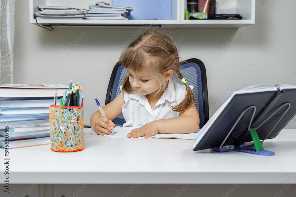little girl doing homework at the table little girl doing homework at the table