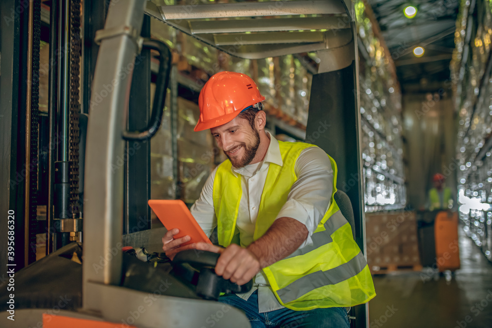 custom made wallpaper toronto digitalYoung bearded worker watching something on the tablet and smiling