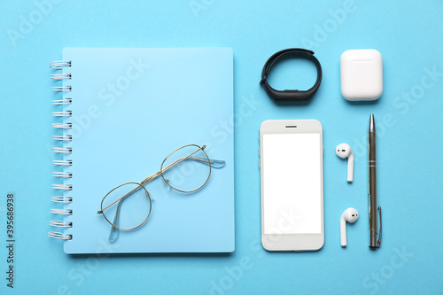 Composition of gadgets and chancellery on color background photo