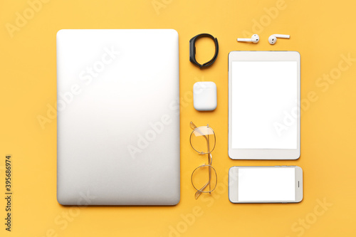 Modern gadgets on color background photo
