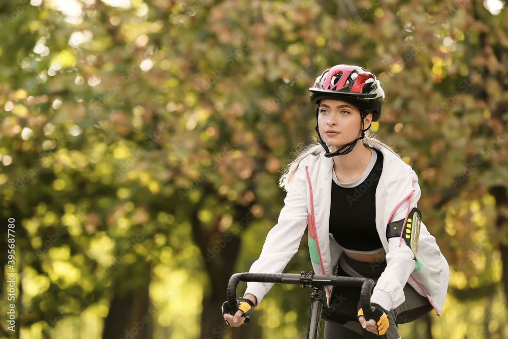 Female cyclist riding bicycle outdoors Female cyclist riding bicycle outdoors