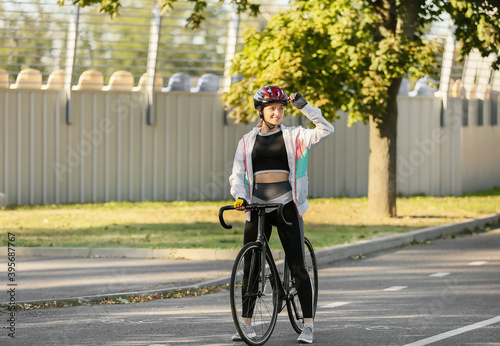 Female cyclist riding bicycle outdoors