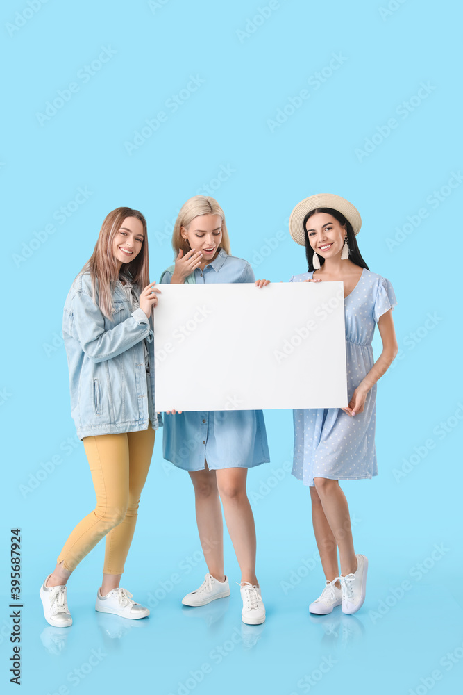 Beautiful young women with blank poster on color background Beautiful young women with blank poster on color background