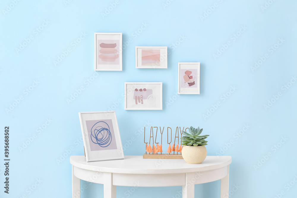 Table near wall with beautiful pictures Table near wall with beautiful pictures
