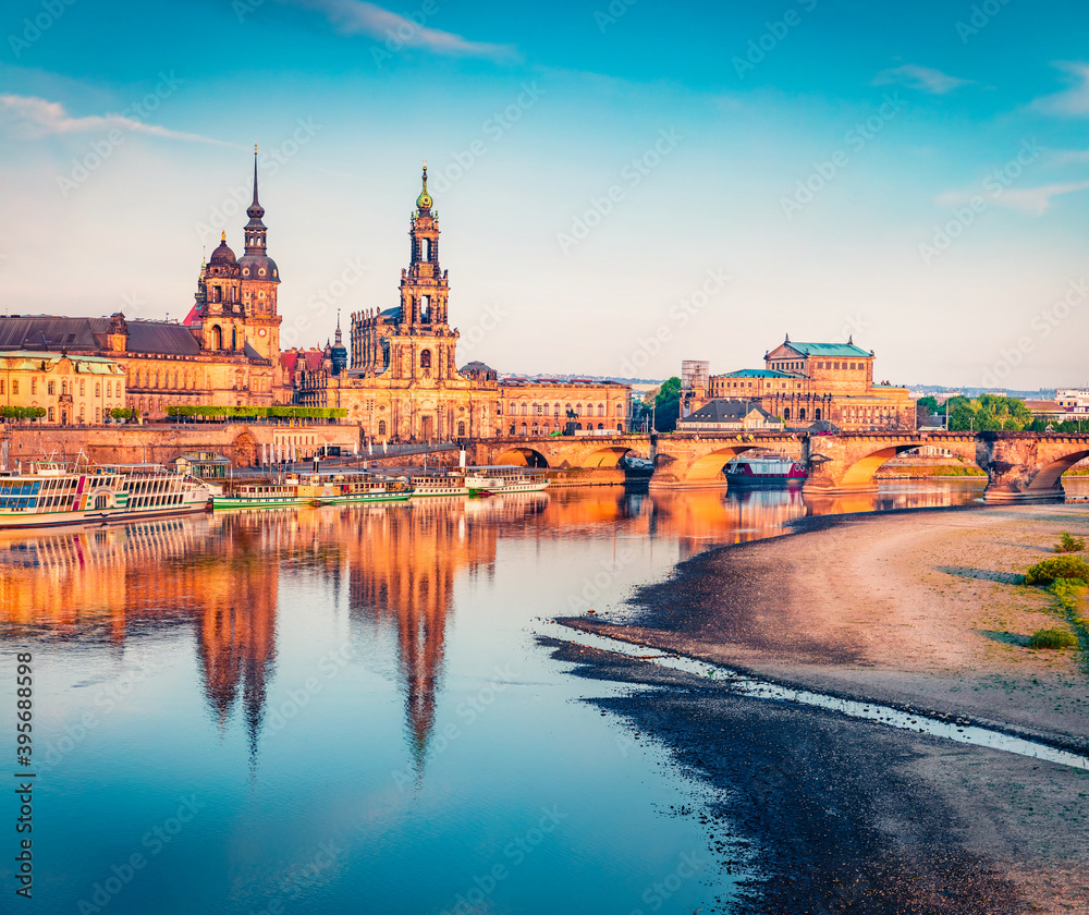 Fototapeta premium Summer evening scene of Cathedral of the Holy Trinity, Hofkirche, Bruehl's Terrace or The Balcony of Europe in Dresden, Saxony, Germany, Europe. Colorful sunset on Elbe river.