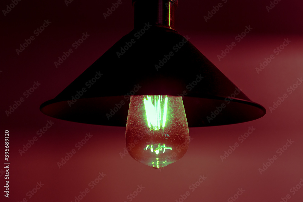 Vintage incandescent lamp in red light