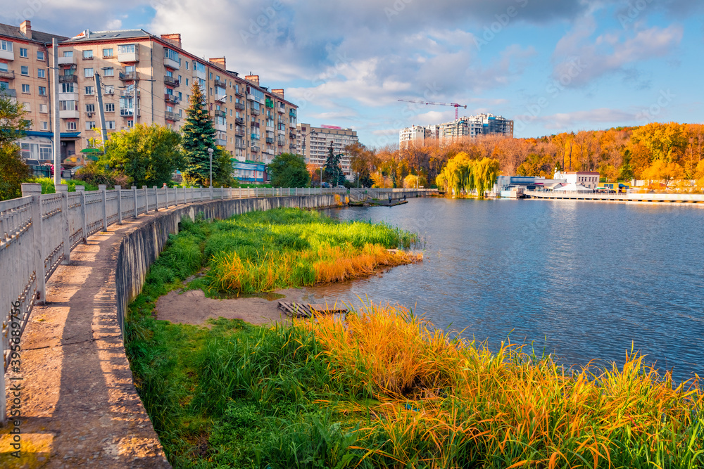 Vivid autumn cityscape of Ternopil town, West Ukraine, Europe. Stunning morning scene of city park with fishing lake. Traveling concept background..