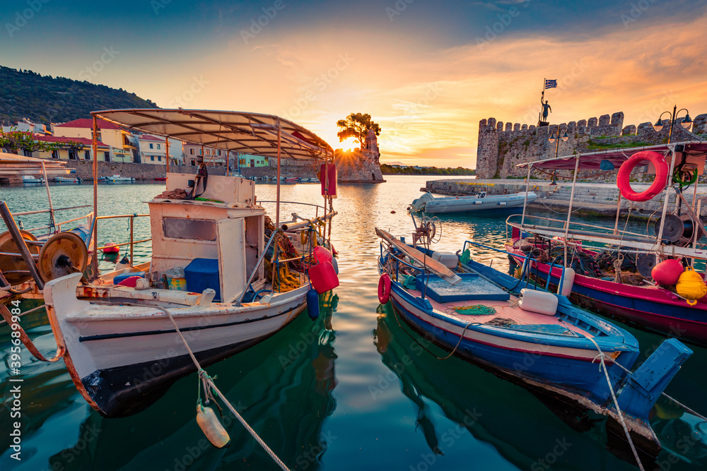 Astonishing morning view of Gulf of Corinth, Greece, Europe. Fantastic sunrise on popular touristic destination - Nafpaktos port. Wonderful  seascape of Ionian sea. Traveling concept background.