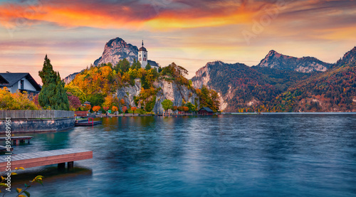 Superb evening view of Johannesbergkapelle church. Incredible autumn scene of Traunsee lake. Colorful landscape of Austrian Alps with Traunstein peak on background, Austria, Europe.